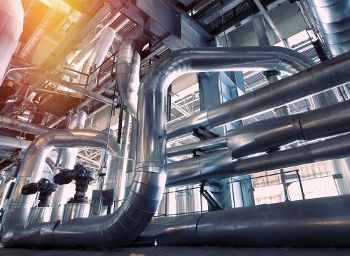 Equipment, cables and piping as found inside of a modern industrial power plant